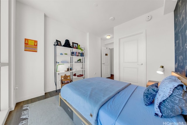 bedroom with dark wood-type flooring