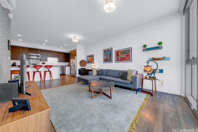 living room featuring dark hardwood / wood-style floors and a wall mounted AC