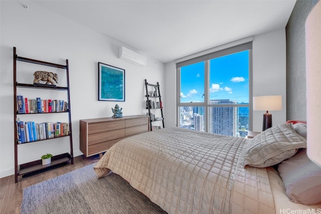 bedroom featuring a wall mounted air conditioner and dark wood-type flooring