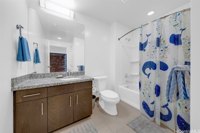 full bathroom featuring toilet, vanity, tile patterned floors, and shower / tub combo