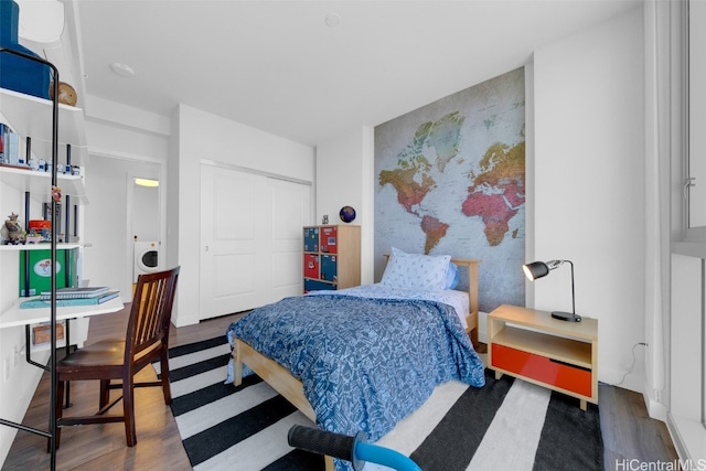 bedroom with dark hardwood / wood-style flooring