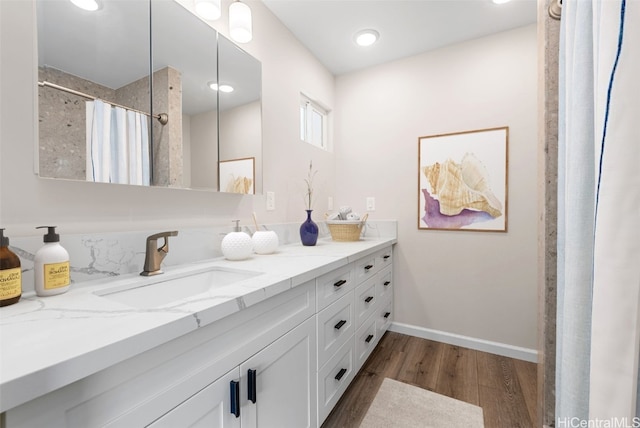 bathroom with hardwood / wood-style floors, vanity, and a shower with shower curtain