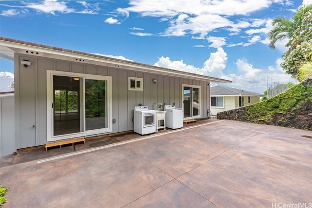 back of property featuring washer and clothes dryer and a patio