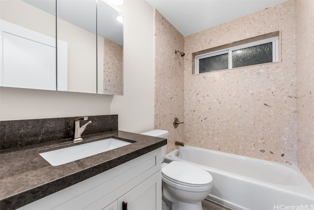 full bathroom with vanity, tiled shower / bath combo, and toilet