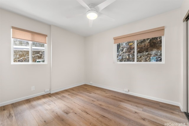 empty room featuring ceiling fan and light hardwood / wood-style flooring