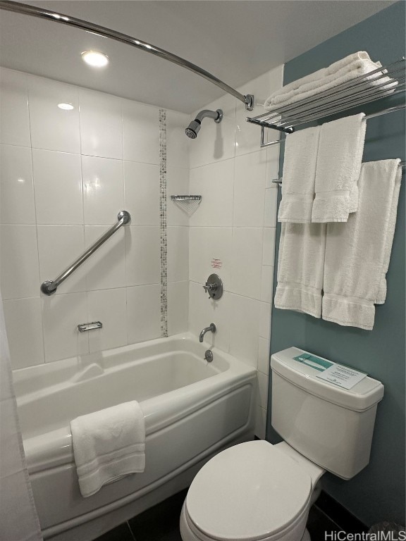 bathroom featuring toilet and tiled shower / bath combo