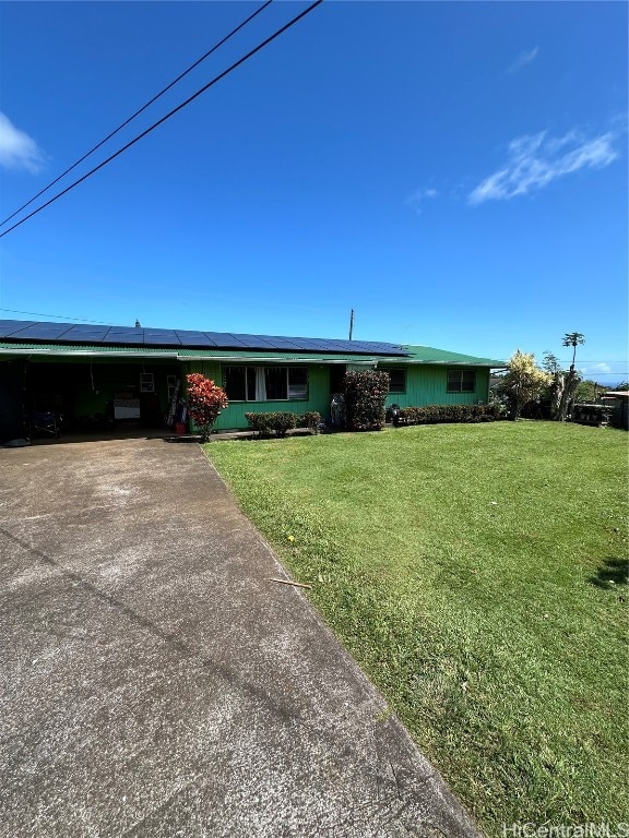 single story home featuring a front lawn and a carport