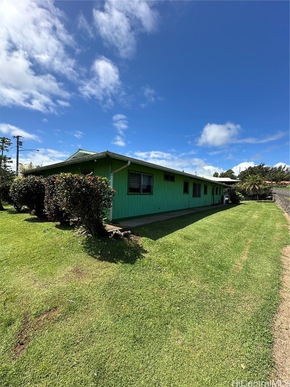 view of side of property with a lawn