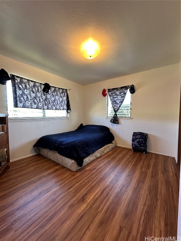 bedroom featuring hardwood / wood-style floors and a textured ceiling