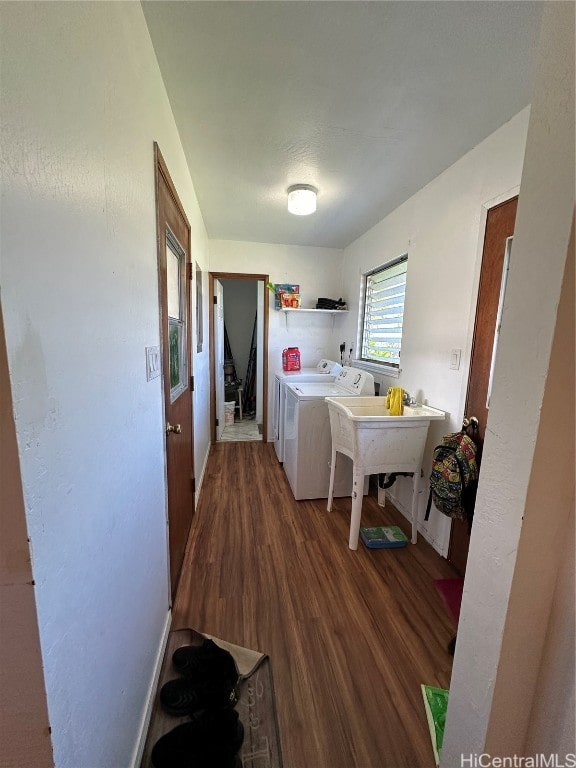 laundry room with hardwood / wood-style floors and washer and clothes dryer