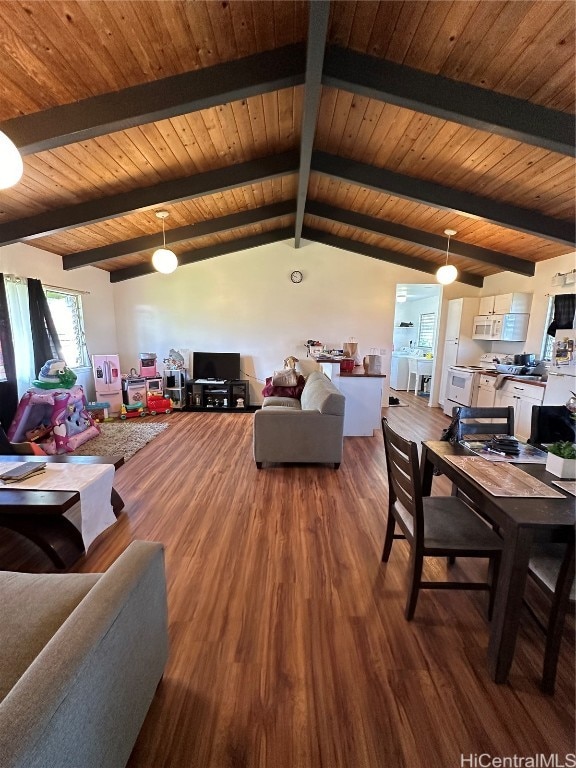 living room with vaulted ceiling with beams and hardwood / wood-style floors