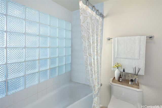 bathroom featuring shower / bath combo and toilet