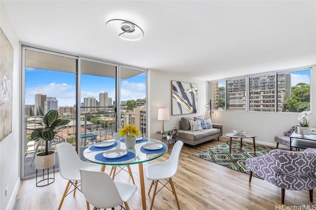 dining space featuring floor to ceiling windows and hardwood / wood-style flooring