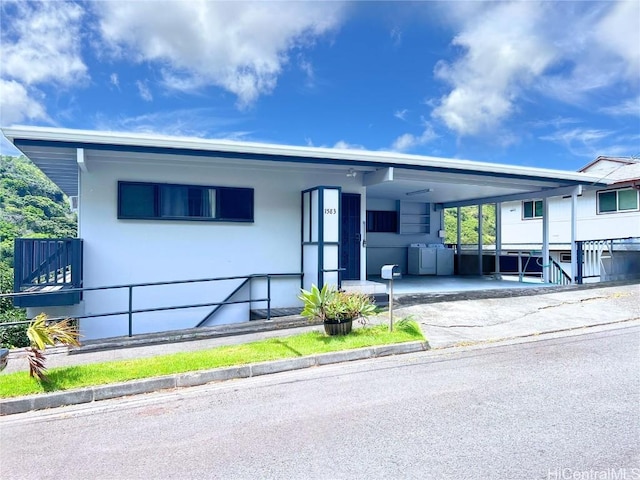 view of front of home featuring a carport