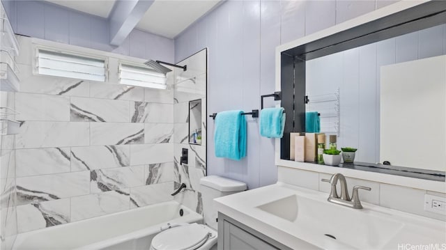 full bathroom with beamed ceiling, vanity, toilet, and tiled shower / bath