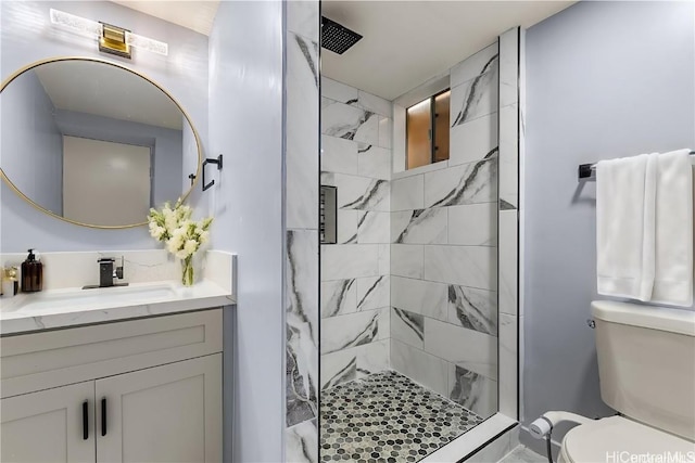 bathroom with an enclosed shower, vanity, and toilet