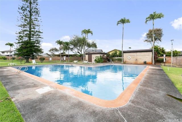 view of pool with a yard and a patio