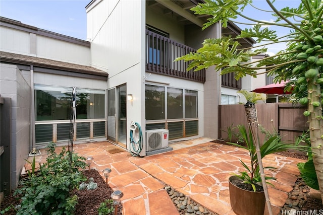 view of patio featuring ac unit and a balcony