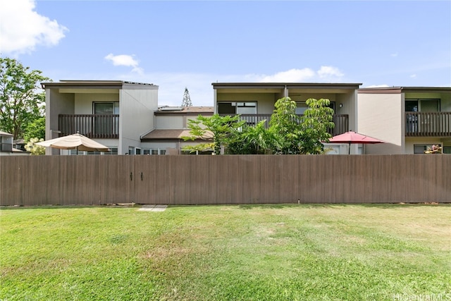 view of yard with a balcony