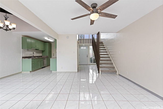 unfurnished living room with light tile patterned flooring, sink, and ceiling fan with notable chandelier