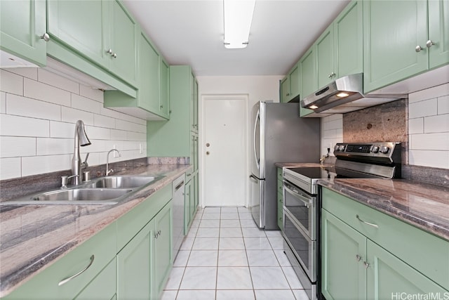 kitchen featuring green cabinets, backsplash, sink, stainless steel range with electric cooktop, and light tile patterned floors