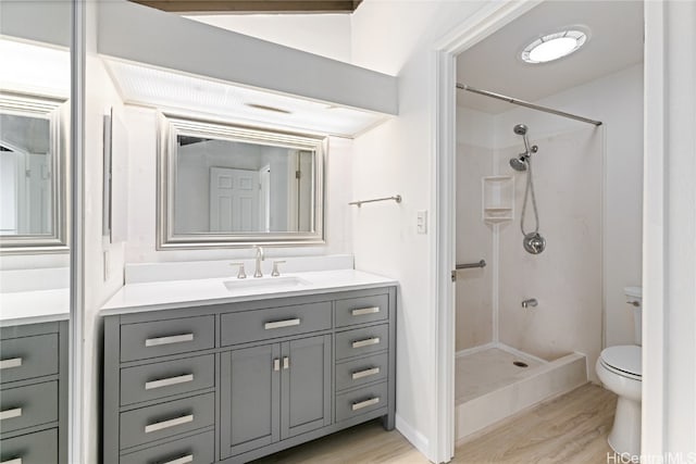 bathroom with vanity, toilet, a shower, and hardwood / wood-style floors