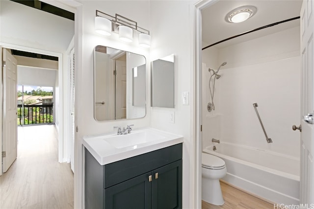 full bathroom with vanity, toilet, wood-type flooring, and bathing tub / shower combination