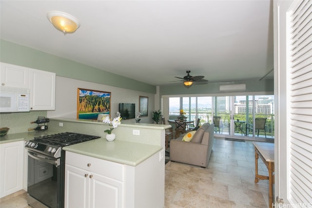 kitchen featuring white cabinetry, black range with gas cooktop, kitchen peninsula, and ceiling fan