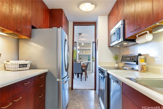 kitchen featuring stainless steel appliances and a textured ceiling