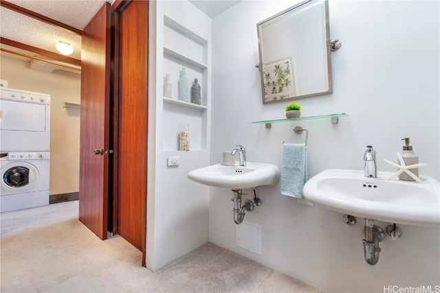 bathroom with stacked washer and clothes dryer and sink