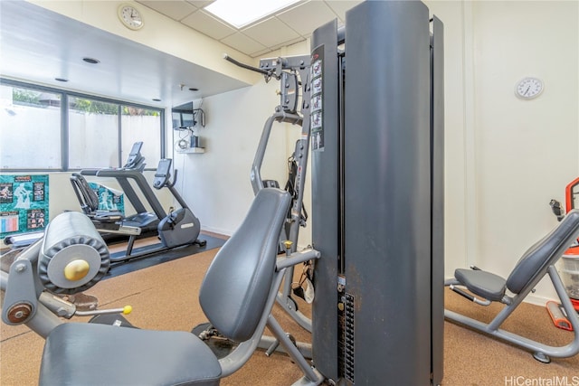 exercise room featuring a paneled ceiling