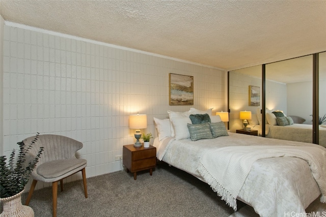 bedroom featuring a closet, a textured ceiling, and carpet floors