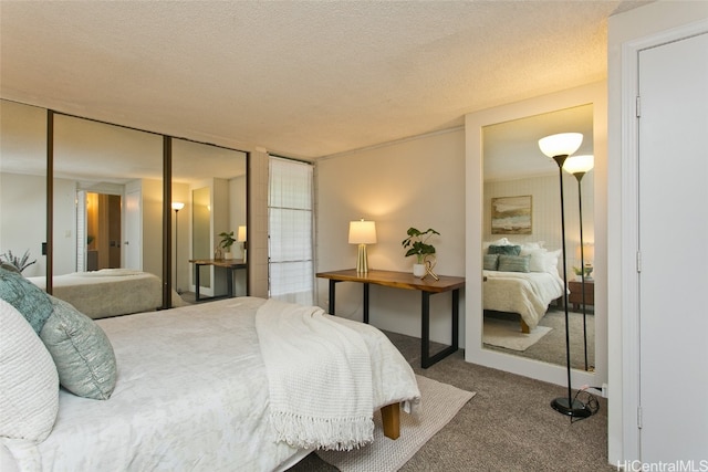 bedroom with a textured ceiling and carpet floors