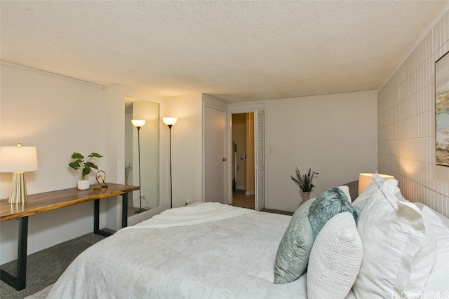 carpeted bedroom featuring a textured ceiling