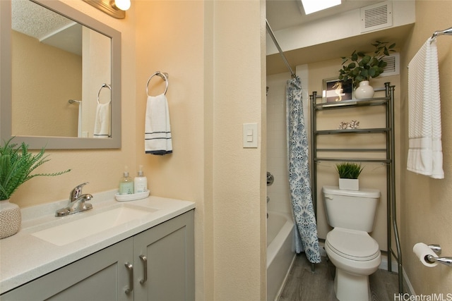 full bathroom featuring vanity, toilet, shower / bath combo with shower curtain, and hardwood / wood-style floors