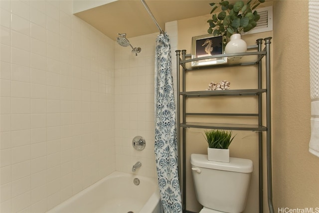 bathroom with shower / tub combo and toilet