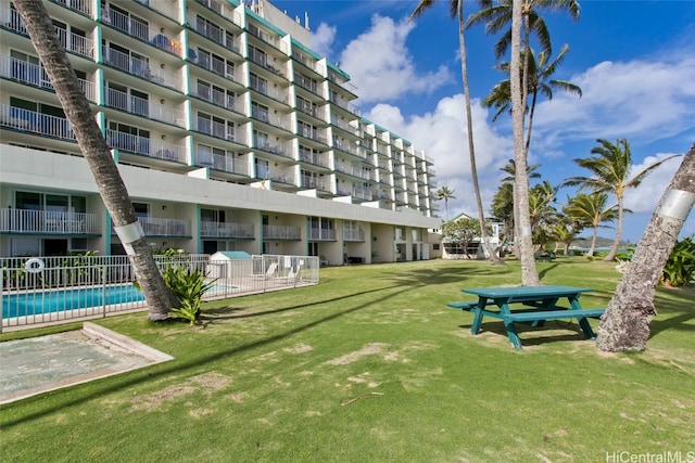 view of community with a lawn and a swimming pool