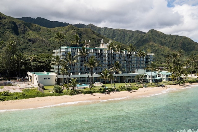 exterior space with a water and mountain view and a beach view