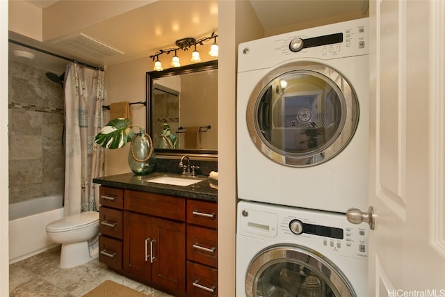 laundry area with stacked washer / dryer and sink