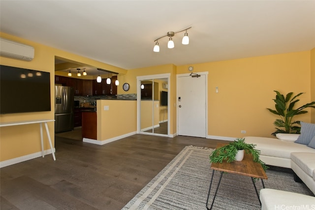 living room featuring dark hardwood / wood-style floors and a wall mounted AC