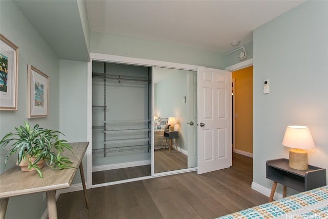 bedroom featuring dark hardwood / wood-style flooring and a closet