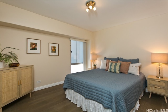 bedroom with dark hardwood / wood-style flooring