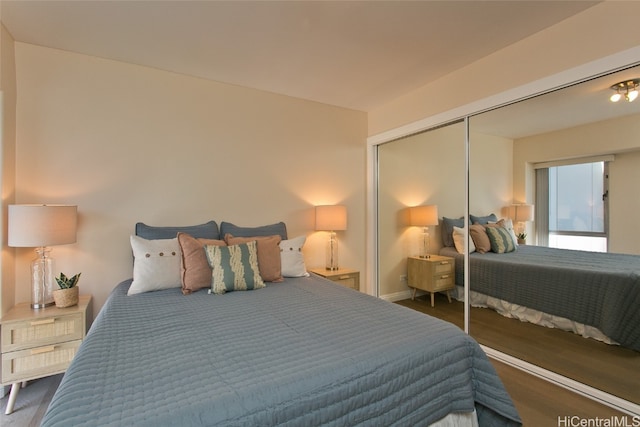 bedroom featuring a closet and dark wood-type flooring