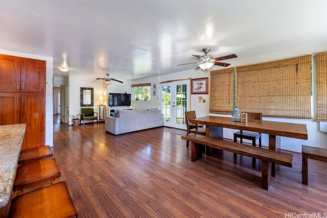 dining room featuring ceiling fan, vaulted ceiling, dark wood-type flooring, and french doors