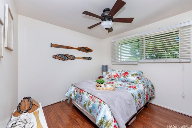 bedroom with ceiling fan and dark hardwood / wood-style flooring