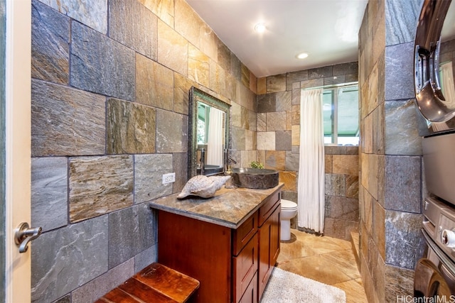 bathroom featuring tile walls and a wealth of natural light