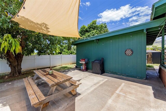 view of patio featuring area for grilling and an outbuilding