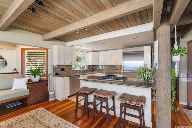 59-557 Ke Iki Rd Unit A, Haleiwa, HI 96712 - kitchen with wood finished floors, a sink, backsplash, and stainless steel appliances