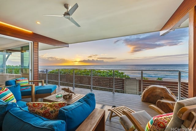 balcony at dusk featuring an outdoor living space, a water view, a view of the beach, and ceiling fan