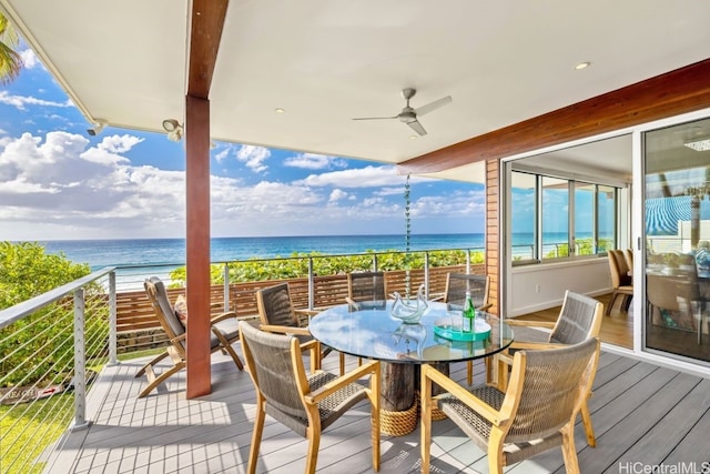 balcony featuring a water view, a beach view, and ceiling fan